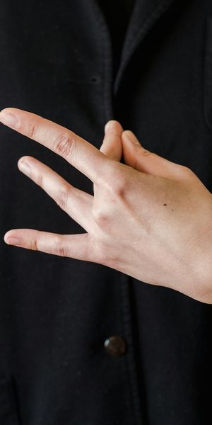Tall image showing a close-up of hands in a meditative mudra.